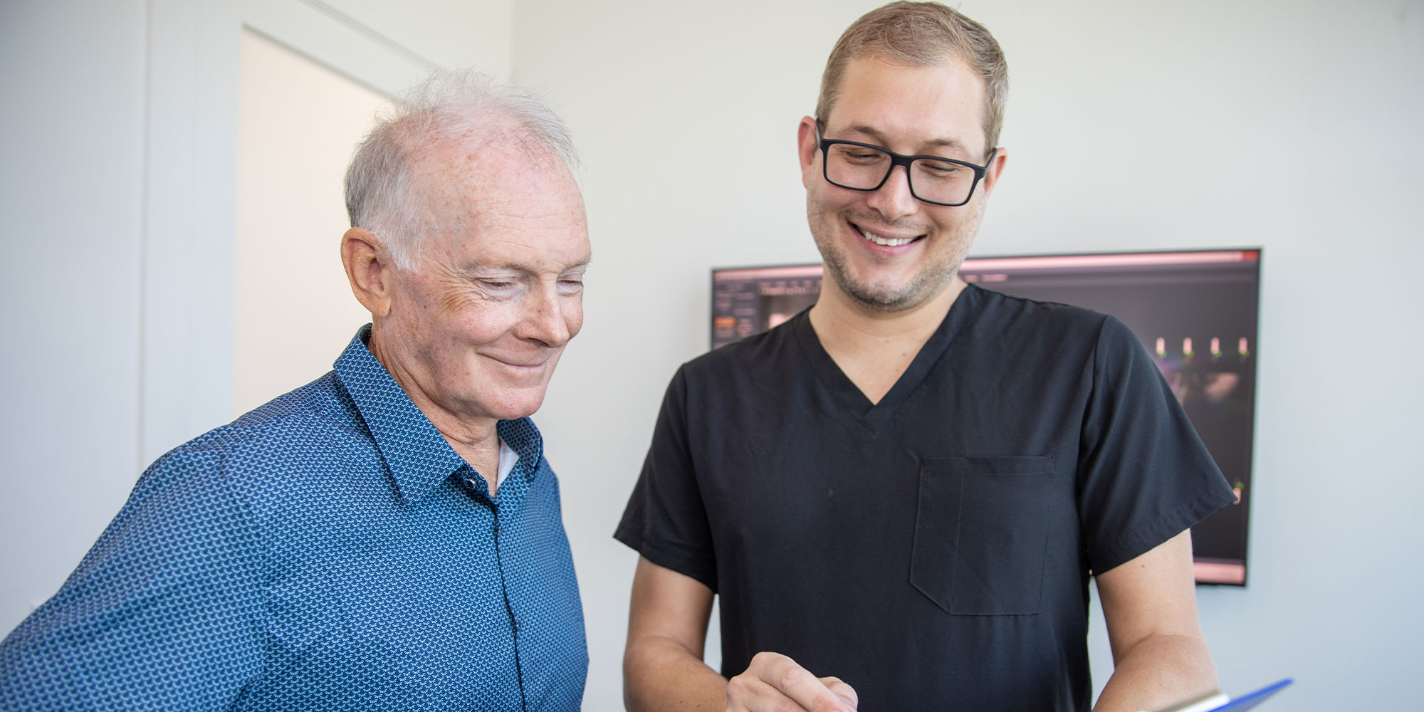 Patient smiling after full mouth dental implant treatment
