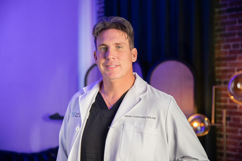 Dr. Steve Caldroney smiling confidently
