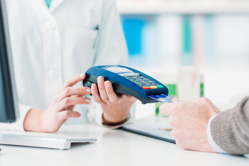 Patient paying for a dental procedure at the front desk