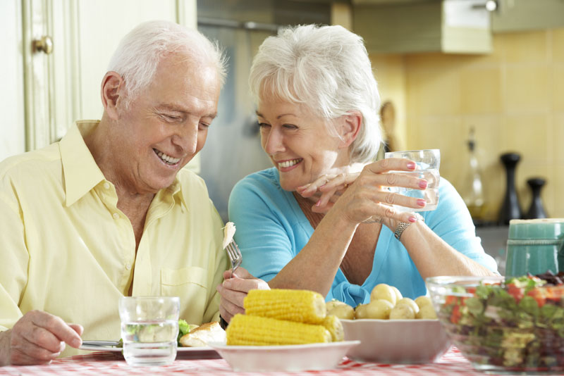 Patient enjoying a meal without worrying about slipping dentures
