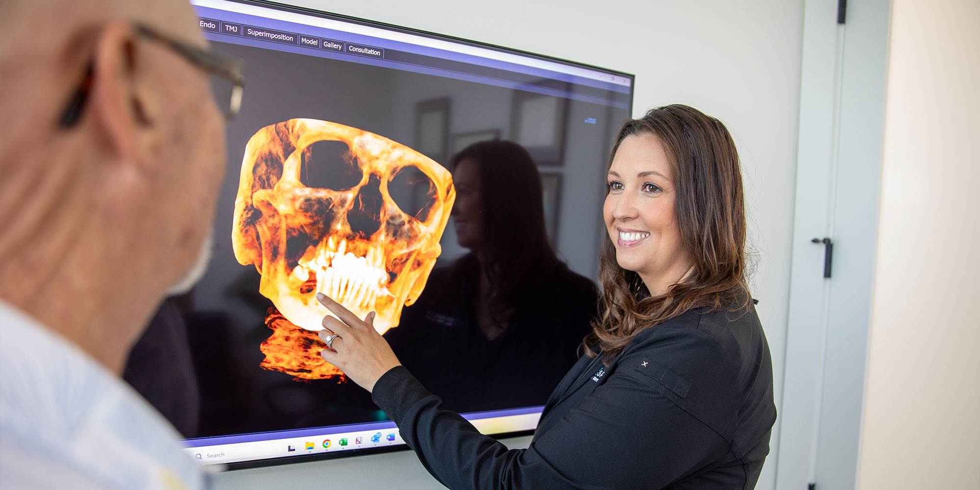 Team member going over an x-ray with a patient