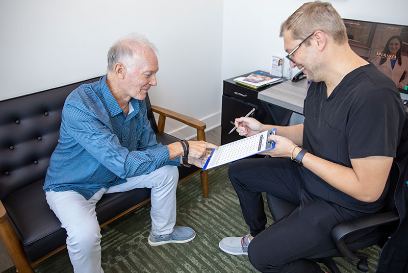 Patient reviewing implant treatment options with a clinician