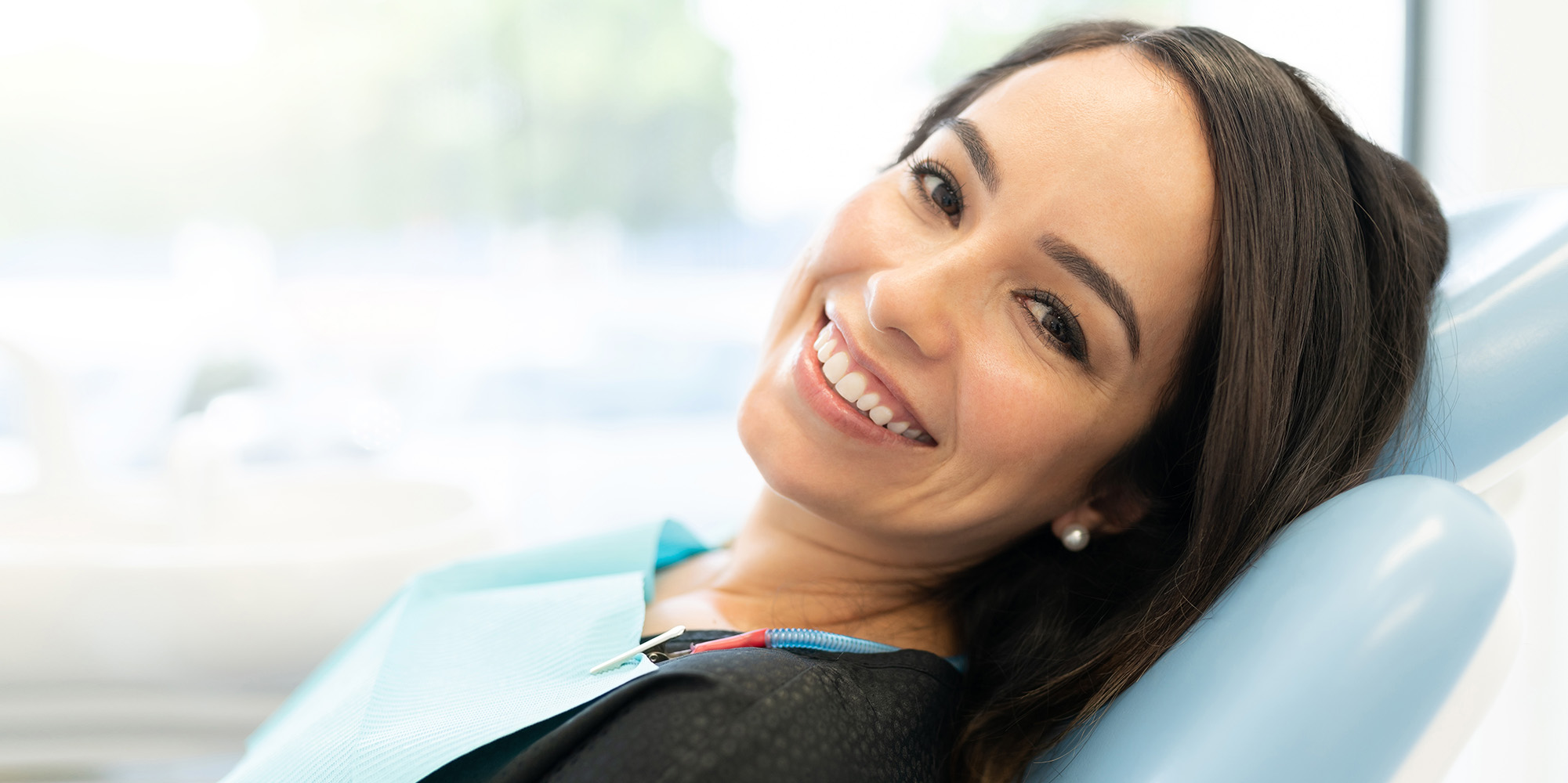 Lady smiling relaxing in the chair after going under dental sedation
